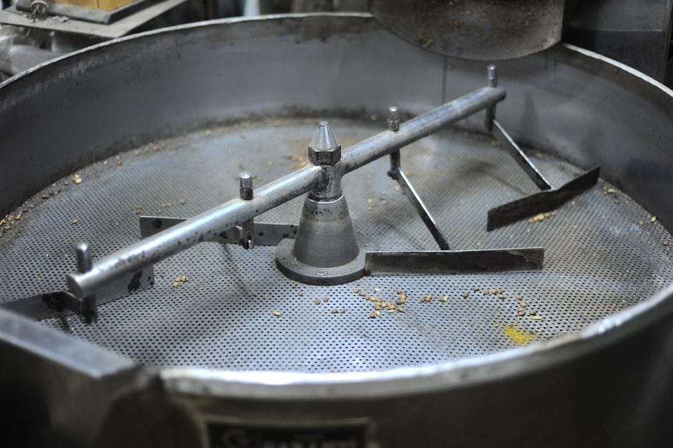 A drum coffee roaster in a small workshop